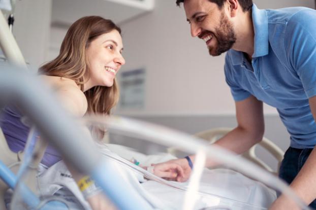 Couple in hospital room happy with recent delivery.