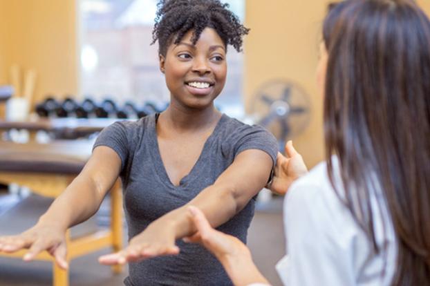 Patient lifting arms with occupational therapist