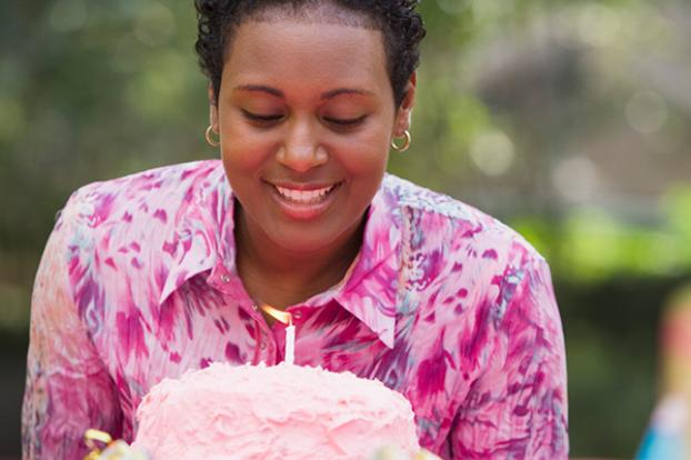 Smile at birthday cake and candle