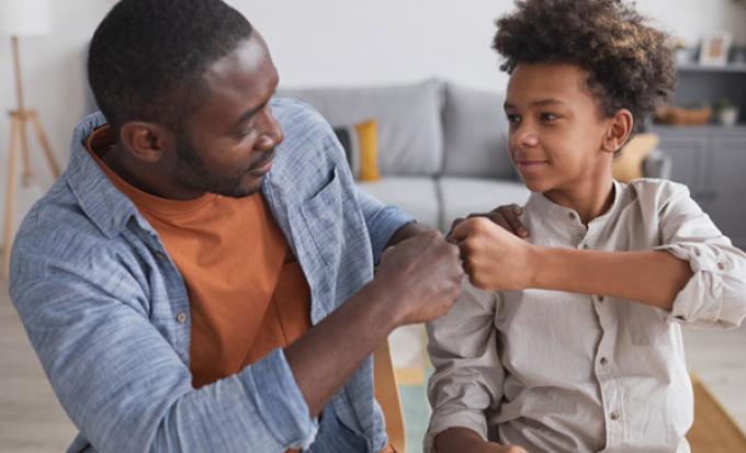 Father and son fist bump