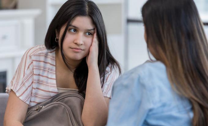 Teen girl talks with mother