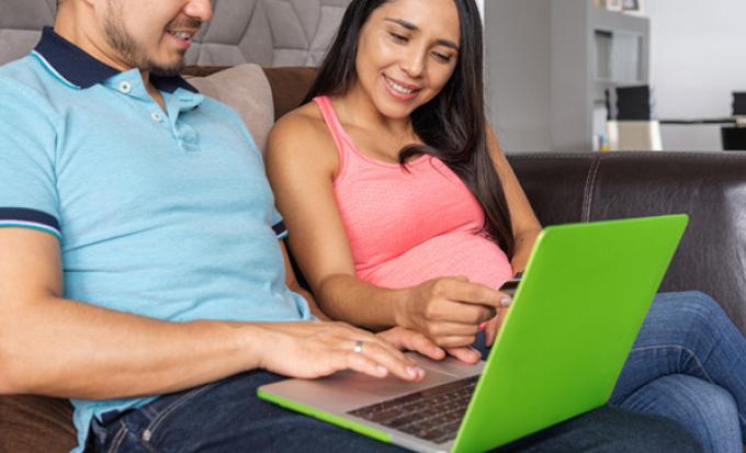 Couple looking at laptop computer.