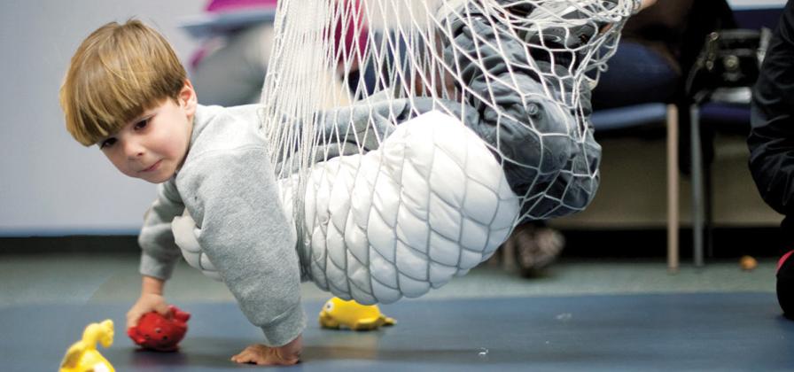 Child in hammock for therapy.