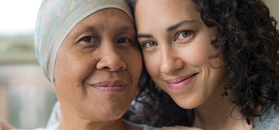 Patient in scarf with supportive daughter.