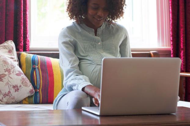 Pregnant mom learning on laptop.