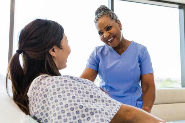 Nurse comforts patient in labor.