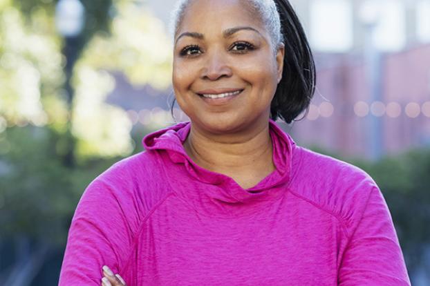 Priority breast health woman in pink shirt.