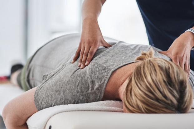 Massage in grey shirt for cancer survivor.