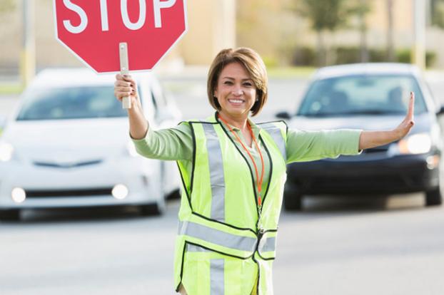 Cross guard directing traffic.