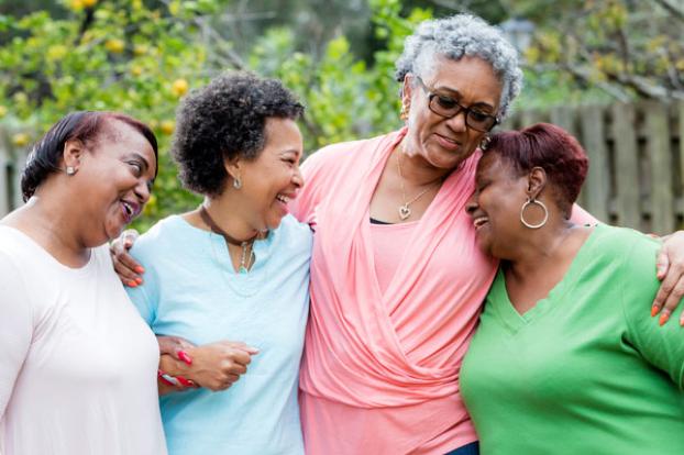 Four friends greet should to shoulder.